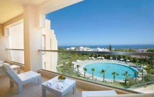 
a beach scene with a balcony overlooking the ocean at Sao Rafael Suites - All Inclusive in Albufeira
