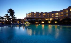 a large swimming pool in front of a building at NAU Sao Rafael Suites - All Inclusive in Albufeira