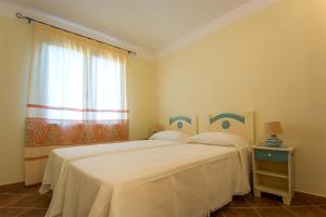 מיטה או מיטות בחדר ב-Appartamenti Sole di Sardegna