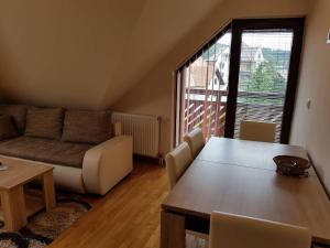 a living room with a couch and a table at Apartment Nina in Zlatibor