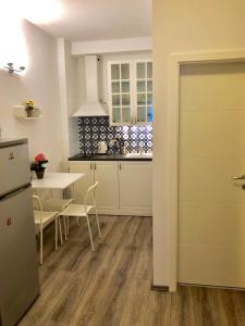 a kitchen with a table and a refrigerator at Apartments Maria in Ljubljana