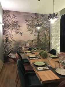 a dining room with a long table and a mural at Hostal Rocamar in Santander