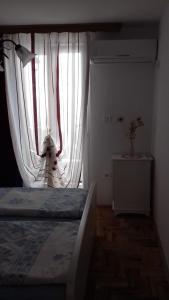 Postel nebo postele na pokoji v ubytování Apartmani Luja