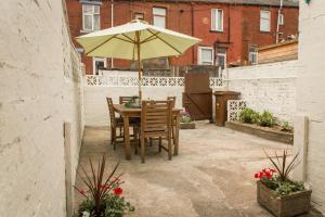 a table and chairs with an umbrella on a patio at Marsden Lodge in Nelson