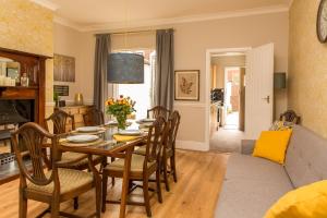 a dining room and living room with a table and chairs at Marsden Lodge in Nelson