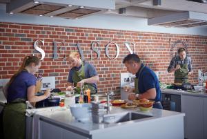 a group of people in a kitchen preparing food at Lainston House in Winchester