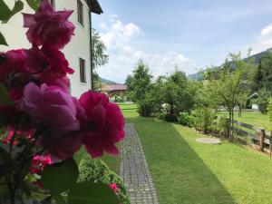 a garden with pink flowers next to a building at Haus Johannes in Wagrain