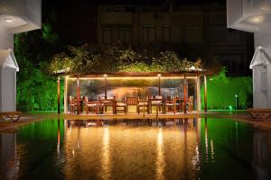 a restaurant with tables and chairs at night at Golden Orange Hotel in Antalya