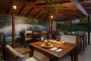 a dining room with a table with food and wine glasses at Golden Orange Hotel in Antalya