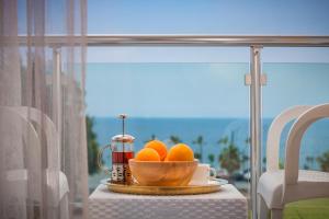 a bowl of oranges on a table next to a window at Golden Orange Hotel in Antalya