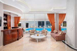 a living room with a couch and a table at Golden Orange Hotel in Antalya