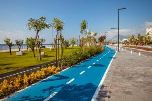 a road with a blue road with palm trees at Golden Orange Hotel in Antalya
