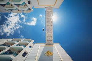 a cross in front of a tall building at Golden Orange Hotel in Antalya