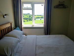 A bed or beds in a room at Seafield Farmhouse