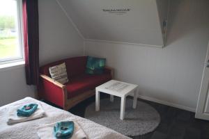 a small room with a couch and a table at 1 Room in The Yellow House, close to Airport & Lofoten in Evenskjer