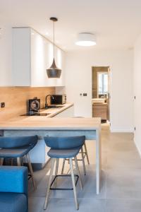 a kitchen with a table and two blue chairs at BCAdria apartments in Split