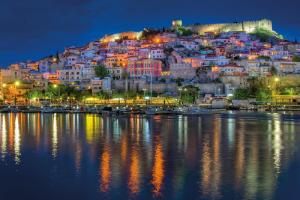 a town on top of a hill at night at Kavala Rooms in Kavala