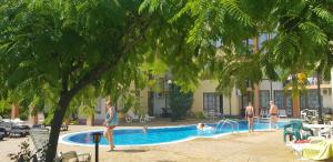 a group of people playing in a swimming pool at Victorio Lux Apartments in Sveti Vlas