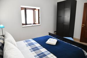a bedroom with a bed with a towel on it at Casa Vacanze Il RossAntico in Modica