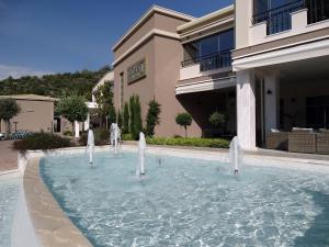 a pool of water in front of a building at Thassos Grand Resort in Alyki