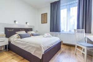 Posteľ alebo postele v izbe v ubytovaní Apartamenty Granitica Zakopane