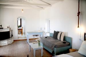 a living room with a couch and a table at Unique Home with Serene Panoramic Views in Kalívia