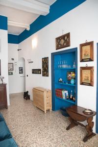 a living room with a blue cabinet and a table at Casa Mira Parasio in Imperia