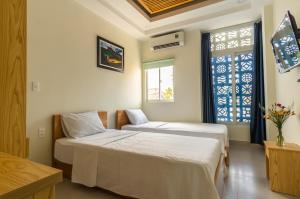 Cama o camas de una habitación en D Central Hoi An Homestay