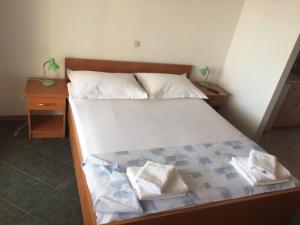 a bedroom with a bed with two towels on it at Apartments Juric in Baška Voda