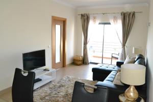 a living room with a couch and a tv at LAGOS MARINA Apartment in Lagos