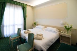 Postel nebo postele na pokoji v ubytování Hotel Terme Antoniano