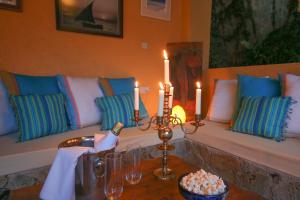 a table with two candles and a bench with pillows at Karen Gables in Nairobi