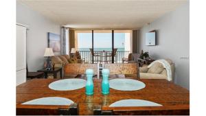 a dining room with a table with two plates on it at Pelican Cove #301 in Clearwater Beach