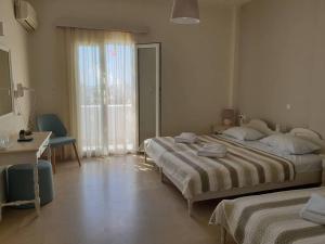 Postel nebo postele na pokoji v ubytování Alkyon Hotel