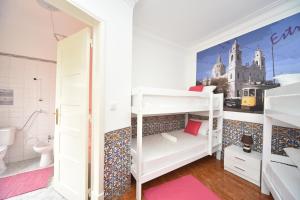 a room with bunk beds and a bathroom at Brother's Rooms in Lisbon