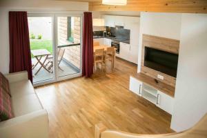 a living room with a kitchen and a dining room at Fishery Steffan in Sankt Kanzian