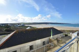 a view of the beach from the balcony of a building at The Penellen guest accommodation room only in Hayle