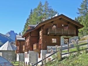 a large wooden house with a balcony at Chalet Selva in Valdidentro