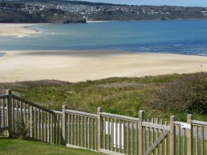 a white picket fence next to a beach at The Penellen guest accommodation room only in Hayle