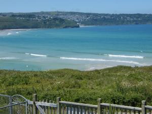 a view of the ocean from a hill with a fence at The Penellen guest accommodation room only in Hayle