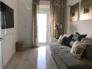a living room with a couch and a window at White Tower Mamaia - Private Apartment in Mamaia