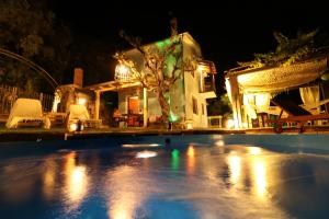 a house with a swimming pool at night at Fakistra's Blue House in Tsagarada +17 photos