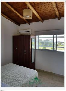 a bedroom with a bed and a large window at Apart del YERUA in Puerto Yeruá +14 photos