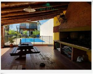 a patio with a table and a swimming pool at Apart del YERUA in Puerto Yeruá