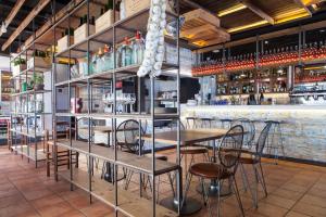 a restaurant with tables and chairs and a bar at URH Sitges Playa in Sitges