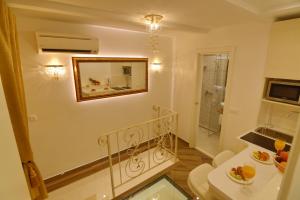a bathroom with a toilet and a mirror on the wall at Villa Madonna della Strada A1 in Dubrovnik