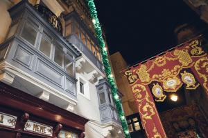 a building with christmas lights on the side of it at Saint Paul Apartment in Valletta
