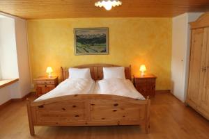 a bedroom with a wooden bed with two night stands at Hotel Lowen in Walenstadt +27 photos