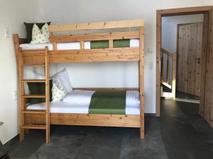 two bunk beds in a room with a door at Family Retreat Maria Alm in Maria Alm am Steinernen Meer