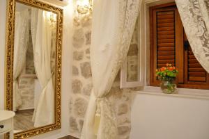 a bathroom with a mirror and a vase of flowers at Villa Madonna della Strada A3 in Dubrovnik +59 photos